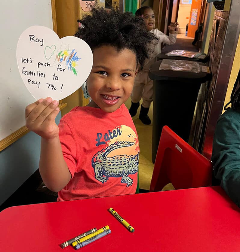 photo of child with push to pay sign photo of child with push to pay sign